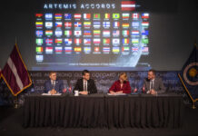 Latvia Joins NASA’s Artemis Accords as Newest Signatory Dace Melbārde, Latvia’s Minister for Education and Science, second from right, signs the Artemis Accords, as NASA Administrator Jared Isaacman, second from left, Jacob Helberg, U.S. Under Secretary of State for Economic Affairs, left, and Jānis Beķeris, Chargé D’Affaires a.i. at the Embassy of the Republic of Latvia to the United States, right, look on Monday, April 20, 2026, at the Mary W. Jackson NASA Headquarters building in Washington. The Artemis Accords graphic of all signatory flags is behind them.