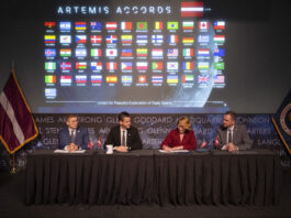 Latvia Joins NASA’s Artemis Accords as Newest Signatory Dace Melbārde, Latvia’s Minister for Education and Science, second from right, signs the Artemis Accords, as NASA Administrator Jared Isaacman, second from left, Jacob Helberg, U.S. Under Secretary of State for Economic Affairs, left, and Jānis Beķeris, Chargé D’Affaires a.i. at the Embassy of the Republic of Latvia to the United States, right, look on Monday, April 20, 2026, at the Mary W. Jackson NASA Headquarters building in Washington. The Artemis Accords graphic of all signatory flags is behind them.