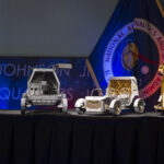 NASA Updates on Rovers, Lunar Modules, and Lunar Base Missions Current image: From left to right, models of the Blue Origin Mark 1 Lunar Lander, Astrolab Crewed Lunar Rover, Lunar Outpost Pegasus rover, and the Firely Elytra Dark orbiter are seen at the conclusion of a news conference to discuss Moon Base, a long-term lunar exploration and infrastructure initiative designed to enable sustained human presence and expanded scientific and commercial activity at the lunar South Pole, Tuesday, May 26, 2026, at the Mary W. Jackson NASA Headquarters building in Washington. Photo Credit: (NASA/Aubrey Gemignani)