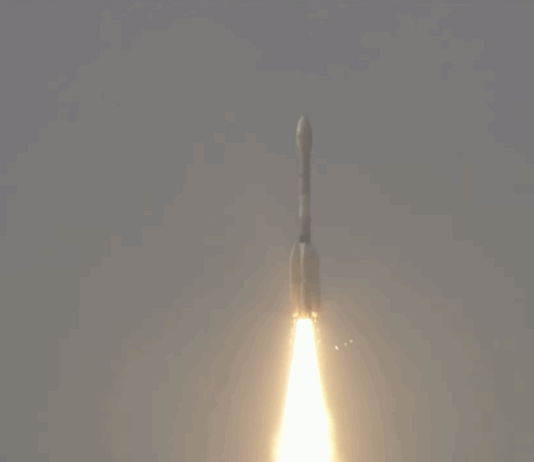 NASA-ISRO Satellite Launched to Monitor Earth’s Surface Changes A large white rocket with a fiery trail launches through a cloudy sky above India.