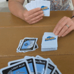 NASA’s NUBE Game Teaches Cloud Identification Through Play A person is shown with cards in their hand that say
