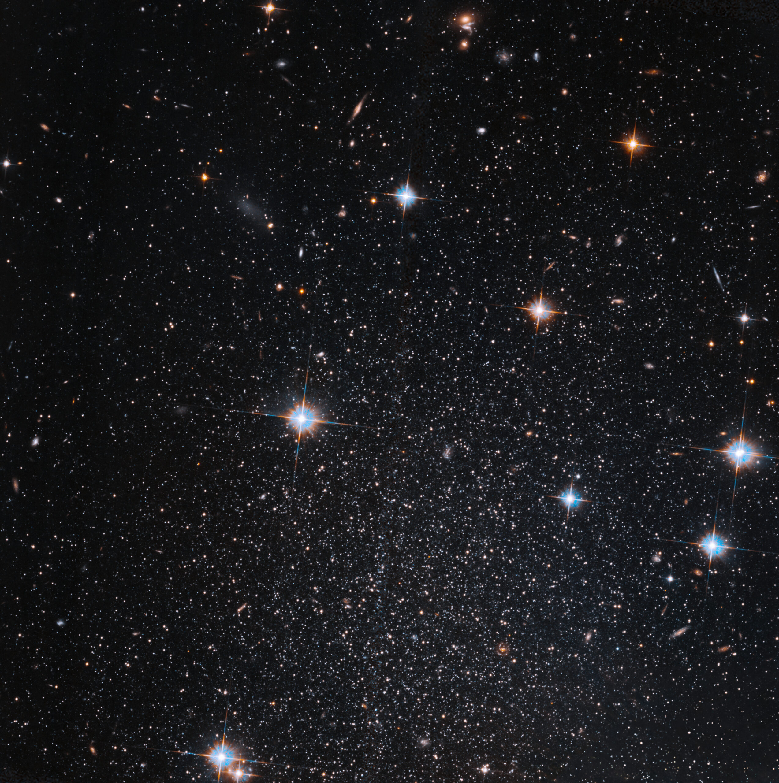 pegasus acs flatcrop cont final.jpg Several stars shine against black space. A few foreground stars with diffraction spikes throughout.
