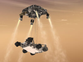 Curiosity’s Sky Crane: Revolutionizing NASA’s Mars Exploration Approach An artist’s concept of the 2012 Mars Curiosity Landing using the skycrane maneuver, with the rover hanging below the hovering spacecraft via three nylon tethers.