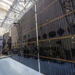 NASA Conducts Tests on Solar Arrays for Europa Clipper Mission Large black rectangular solar arrays stretch out from the foreground to the back.