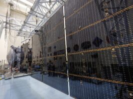 NASA Conducts Tests on Solar Arrays for Europa Clipper Mission Large black rectangular solar arrays stretch out from the foreground to the back.