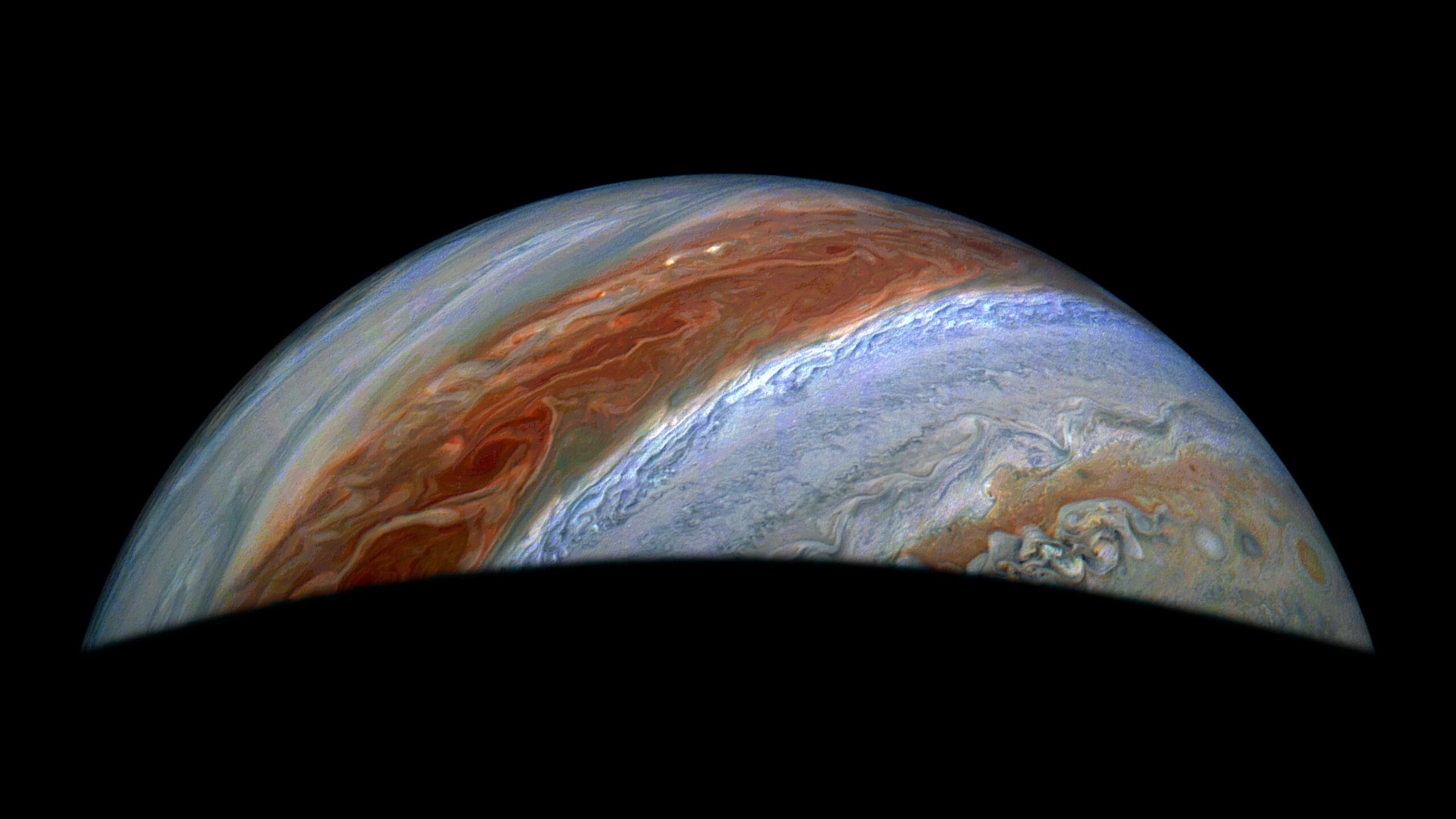 pia26595orig.jpg Part of Jupiter is visible in this image. Its iconic belts and zones stand out in rusty red and blue, along with turbulent activity on their edges.