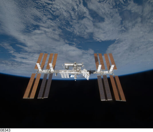 Understanding the International Space Station for Middle Schoolers Backdropped by the blackness of space and Earth