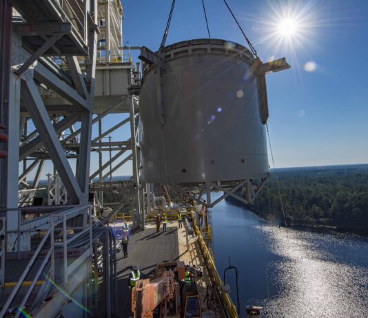 NASA Stennis Reaches Key Step for Upcoming Artemis Tests interstage simulator component suspended in air by crane