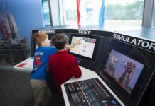 NASA Exhibit Lets You Experience Being a Test Conductor A pair of young visitors to INFINITY Science Center