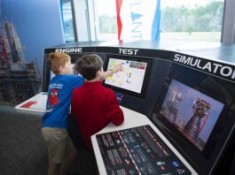 NASA Exhibit Lets You Experience Being a Test Conductor A pair of young visitors to INFINITY Science Center
