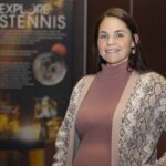 Heather Seagren Streamlines Travel for NASA Staff Heather Seagren pauses for a photo in front of an Explore Stennis poster