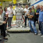 NASA Recognized Among Top U.S. Employers for Veterans Group photo of NASA SkillBridge employees around an Astronaut suit at the JSC Neutral Buoyancy Laboratory.