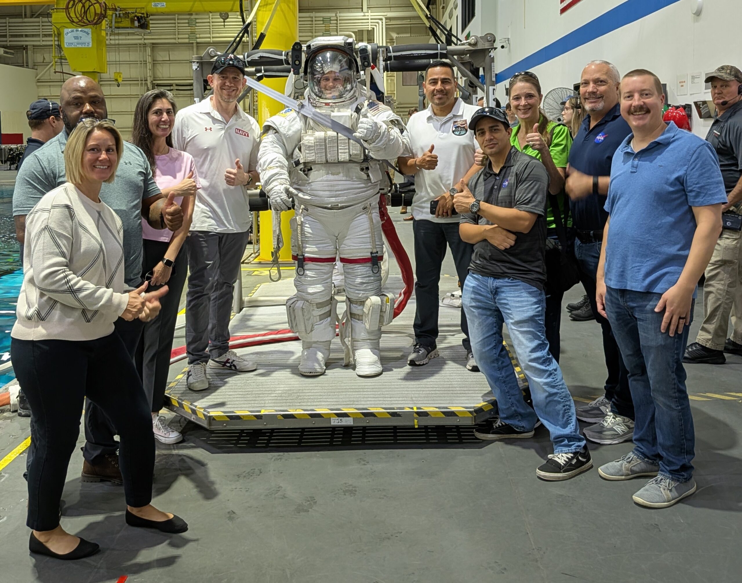 skillbridge group pic3.jpg Group photo of NASA SkillBridge employees around an Astronaut suit at the JSC Neutral Buoyancy Laboratory.