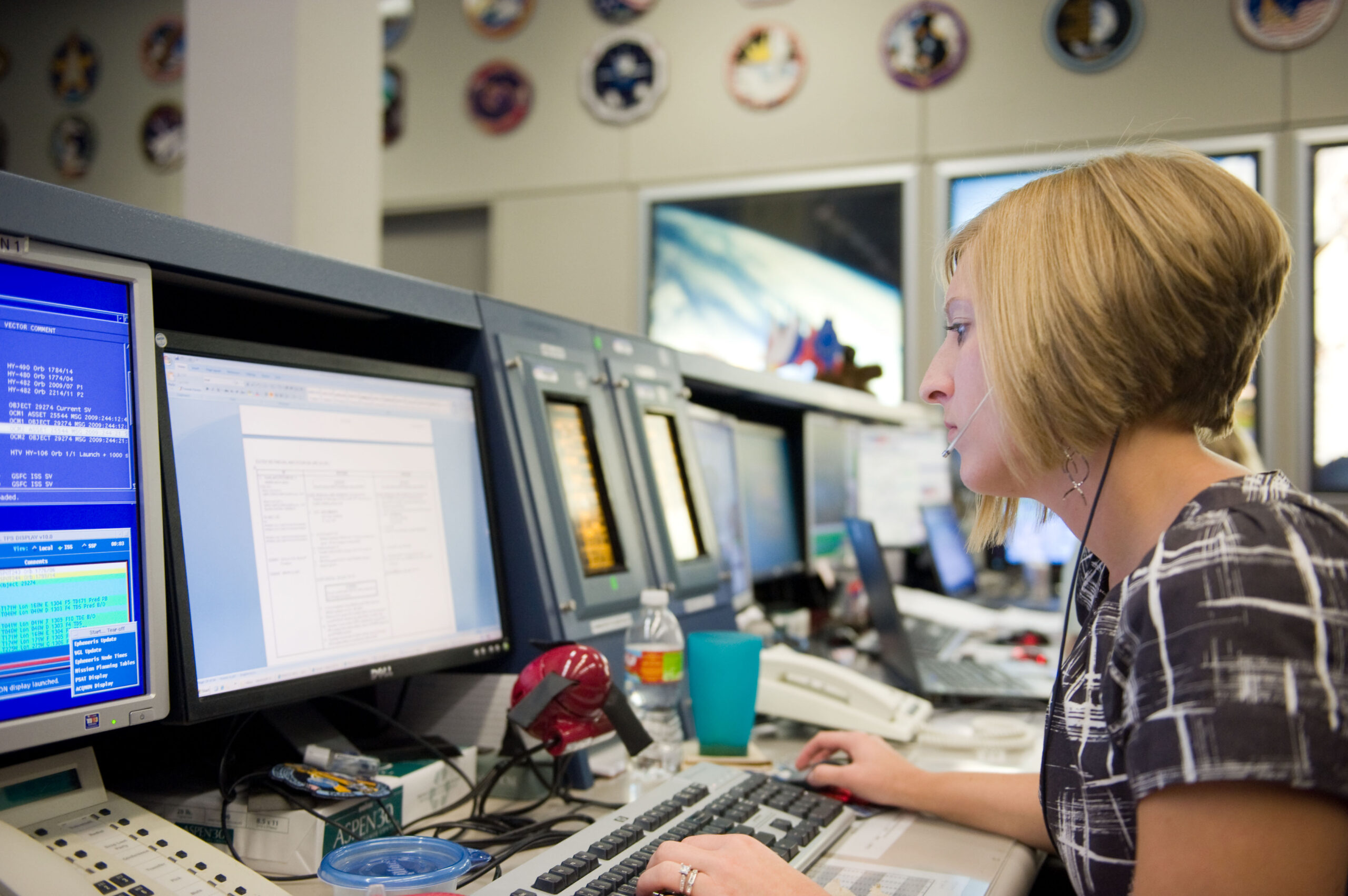 sts 128 17a 2009.jpg A woman sits in front of a bank of computer screens in the Mission Control Center at Johnson Space Center.