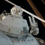 15-Year Anniversary: Tranquility, Cupola Delivered to ISS by STS-130 Two astronauts wearing white spacesuits work on the outside of the space station.
