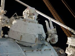 15-Year Anniversary: Tranquility, Cupola Delivered to ISS by STS-130 Two astronauts wearing white spacesuits work on the outside of the space station.