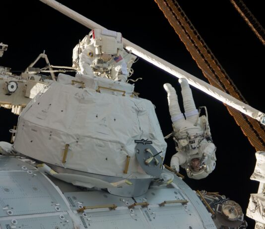 15-Year Anniversary: Tranquility, Cupola Delivered to ISS by STS-130 Two astronauts wearing white spacesuits work on the outside of the space station.