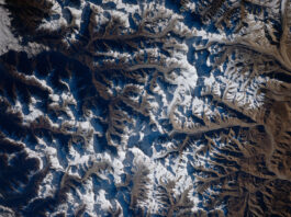 NASA Captures Mount Everest Image from Space A view of Mount Everest and the surrounding area from space. White snow can be seen on mountains; valleys and shadows appear blue-gray.