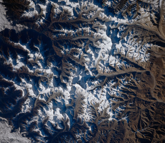 NASA Captures Mount Everest Image from Space A view of Mount Everest and the surrounding area from space. White snow can be seen on mountains; valleys and shadows appear blue-gray.