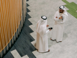 TAMM revolutionizes Abu Dhabi government services with AI innovation Two men in traditional Emirati clothing talking as seen from above.