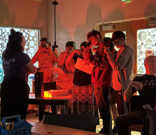 NASA’s Unforgettable 2024 Highlight A group of students peer through devices