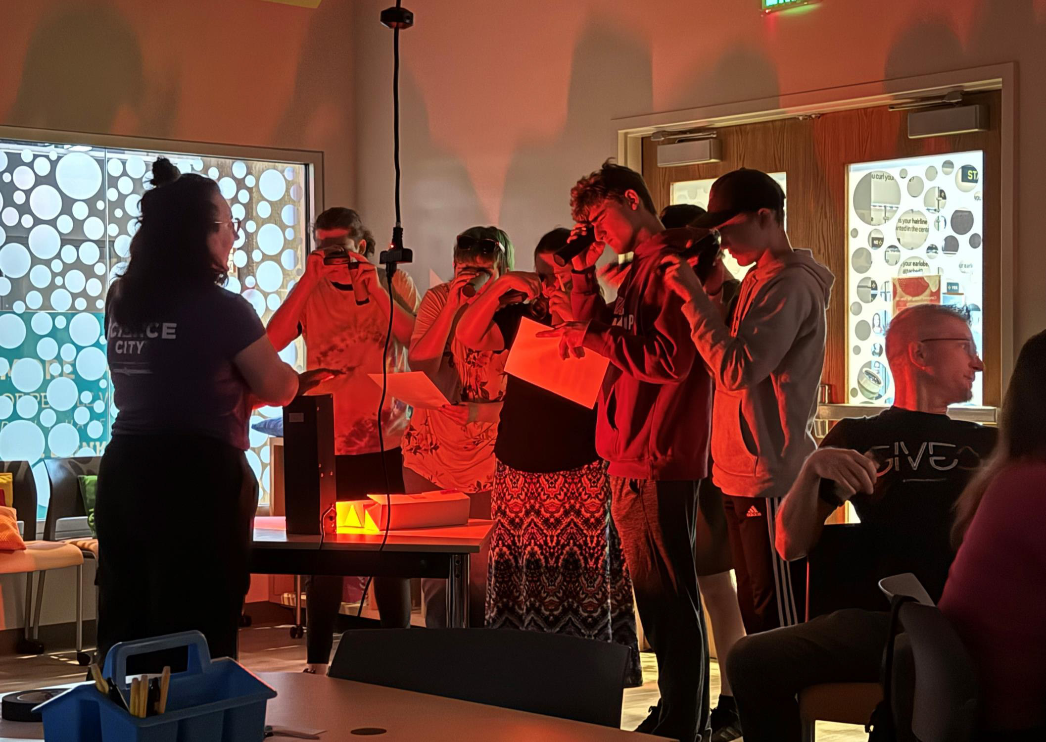 team ii memorable moment.jpg A group of students peer through devices