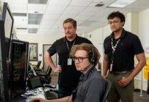 Marshall’s NASA Tools Aid Space Station Operations Three men standing inside a computer room reviewing information on a computer screen.