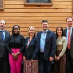 Lenovo and University of Southampton Collaborate on High-Performance Computing A line of men and women in business smiling at the camera in front of a wooden background