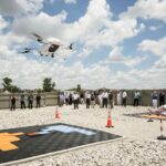 NASA Explores UTM BVLOS for Uncrewed Aircraft Traffic Management NASA, along with members of the FAA and commercial drone engineers, gather outside to view a drone demonstration flight by Wisk on May25, 2024.