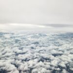 NASA’s 3D Laser Winds Enhance Air and Space Forecasting The image shows an aerial view of grey skies above and thick, broken cloud cover below.