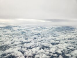 NASA’s 3D Laser Winds Enhance Air and Space Forecasting The image shows an aerial view of grey skies above and thick, broken cloud cover below.