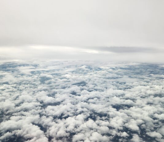 NASA’s 3D Laser Winds Enhance Air and Space Forecasting The image shows an aerial view of grey skies above and thick, broken cloud cover below.