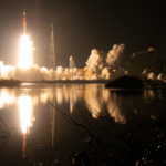 NASA Unveils New Virtual Backgrounds Celebrating Artemis Missions Framed by vegetation in the foreground and against the backdrop of a black night sky, NASA’s SLS (Space Launch System) rocket carrying the Orion spacecraft launches on the Artemis I flight test on Nov. 16, 2022, from Launch Complex 39B at NASA’s Kennedy Space Center in Florida.