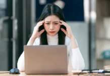 Cloudflare Outage Brings Down Major Websites – Here’s How to Stay Online woman working on laptop having a headache 2024 12 06 08 38 26 utc converted from jpg