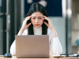 Cloudflare Outage Brings Down Major Websites – Here’s How to Stay Online woman working on laptop having a headache 2024 12 06 08 38 26 utc converted from jpg