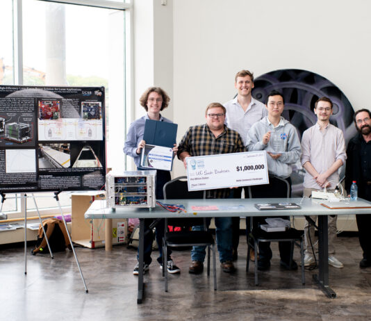 NASA’s Watts on the Moon Challenge Concludes with $1.5M Prizes At the Great Lakes Science Center in Cleveland, Ohio, Team H.E.L.P.S. (High Efficiency Long-Range Power Solution) from The University of California, Santa Barbara pose with their $1 million check and the power transmission and energy storage hardware that won them the grand prize in the four-year competition. The team is comprised of six faculty researchers at UC Santa Barbara, led by team lead Dr. Philip Lubin (far right).