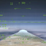 NASA’s X-59 Aircraft Achieves First Supersonic Flight NASA’s X 59 eXternal Vision System digital display shows green flight data overlaid on the forward scenery as the aircraft flies supersonic. Numerical indicators, horizon references, and a Mach number readout are visible on the screen.