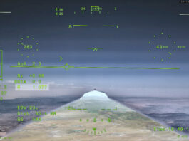 NASA’s X-59 Aircraft Achieves First Supersonic Flight NASA’s X 59 eXternal Vision System digital display shows green flight data overlaid on the forward scenery as the aircraft flies supersonic. Numerical indicators, horizon references, and a Mach number readout are visible on the screen.